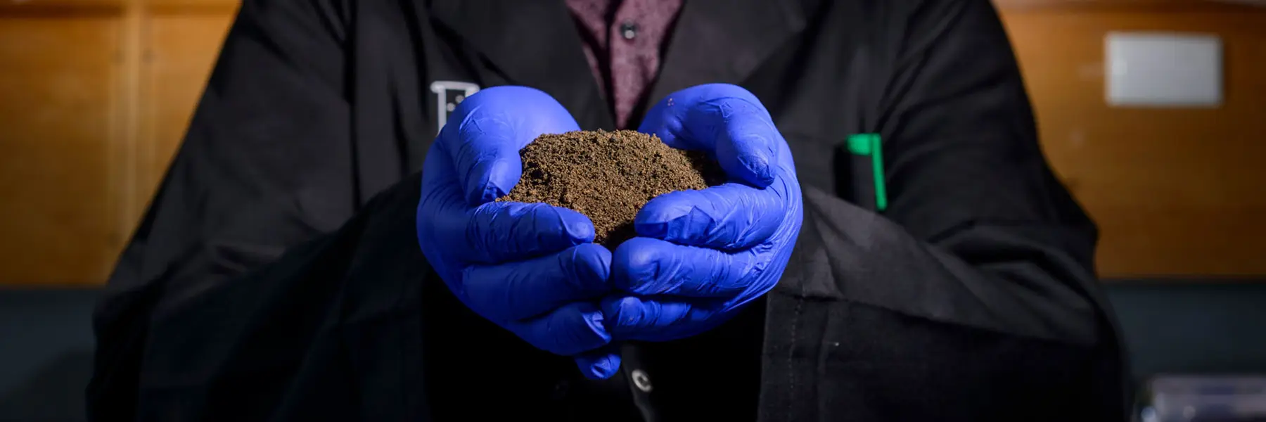 Chalker-Dirt-Hands Dirt in hands with blue gloves on