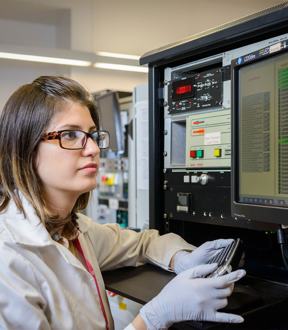 Female scientist opperating computer equipment