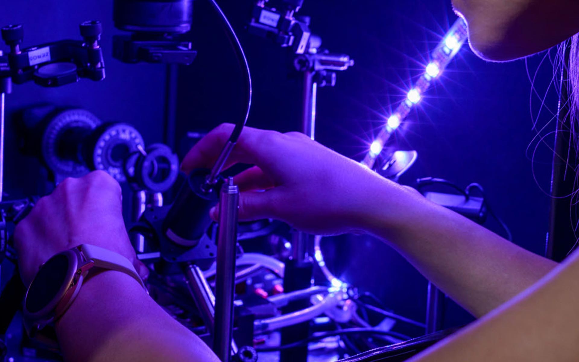 Technician operating optical lab equipment Technician operating optical lab equipment