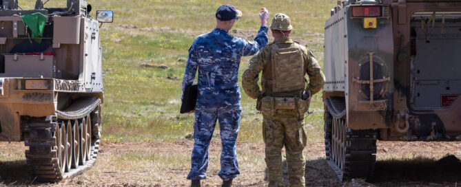 Royal Australian Air Force and Army personnel discuss the displays as part of the Land Autonomous Systems & Teaming–Demonstration at Puckapunyal Military area, September 2024.