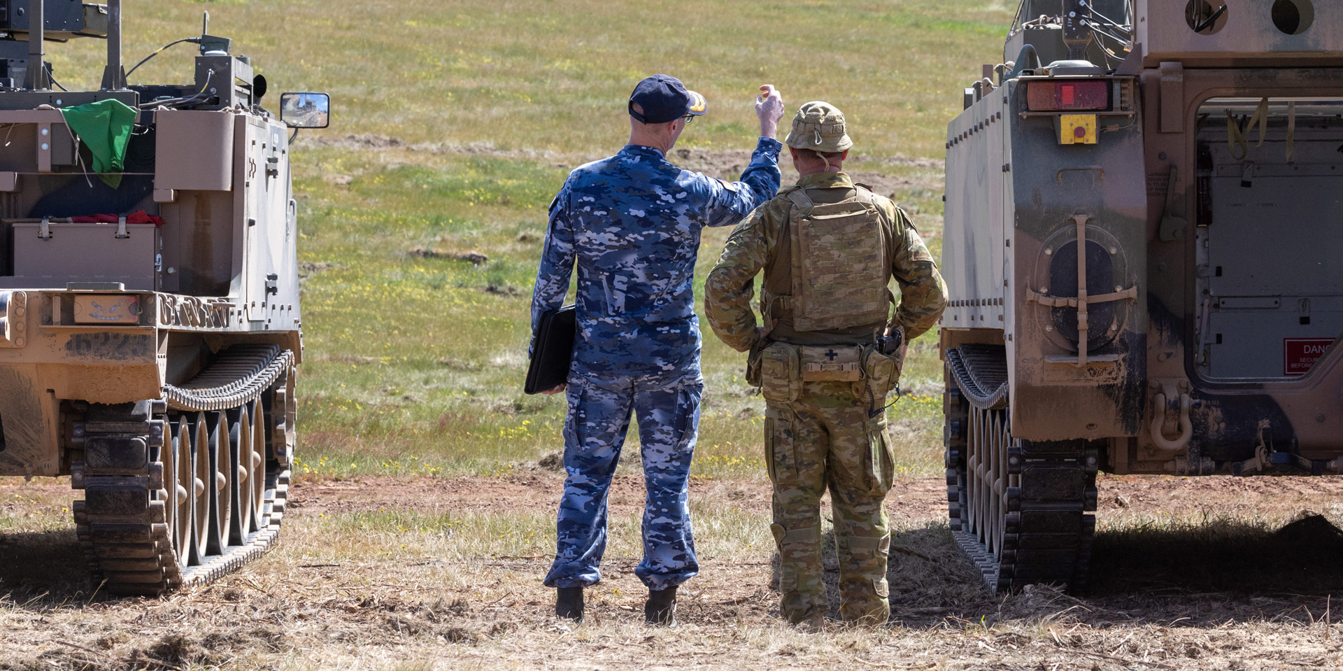 Royal Australian Air Force and Army personnel discuss the displays as part of the Land Autonomous Systems & Teaming–Demonstration at Puckapunyal Military area, September 2024.