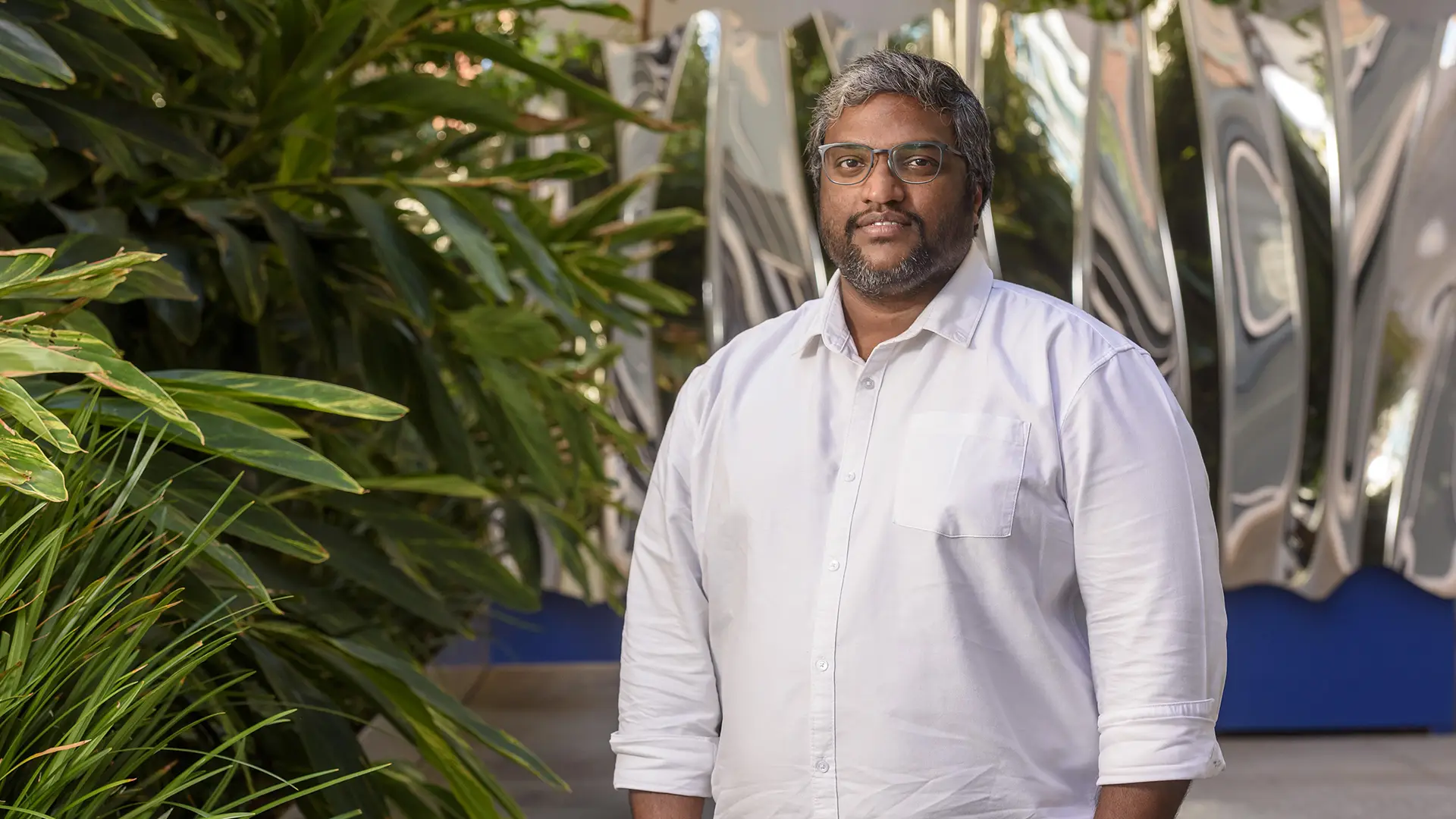 Round three South Australian Space Collaboration and Innovation Fund recipient A man standing in front of an abstract, modern-looking building