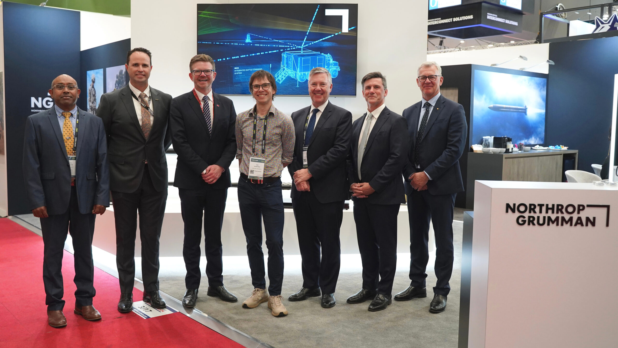 Men in suits at a defence expo